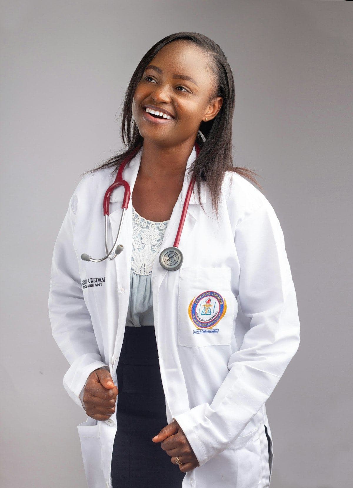 A doctor in a white coat with a stethoscope, smiling.